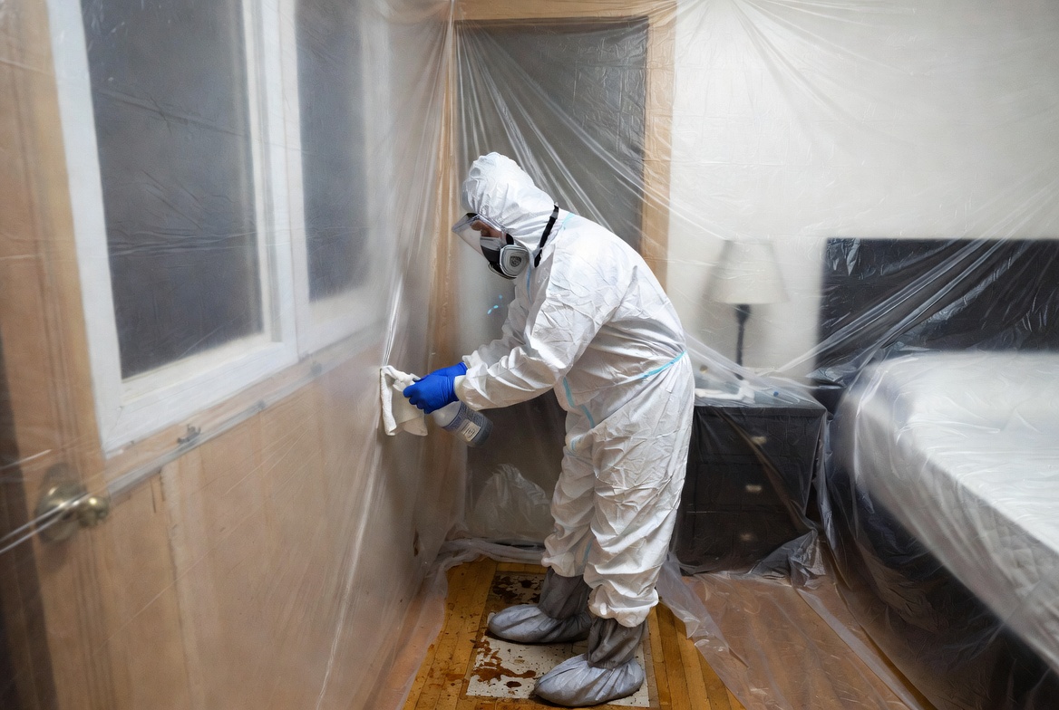 Certified technician performing professional crime scene decontamination